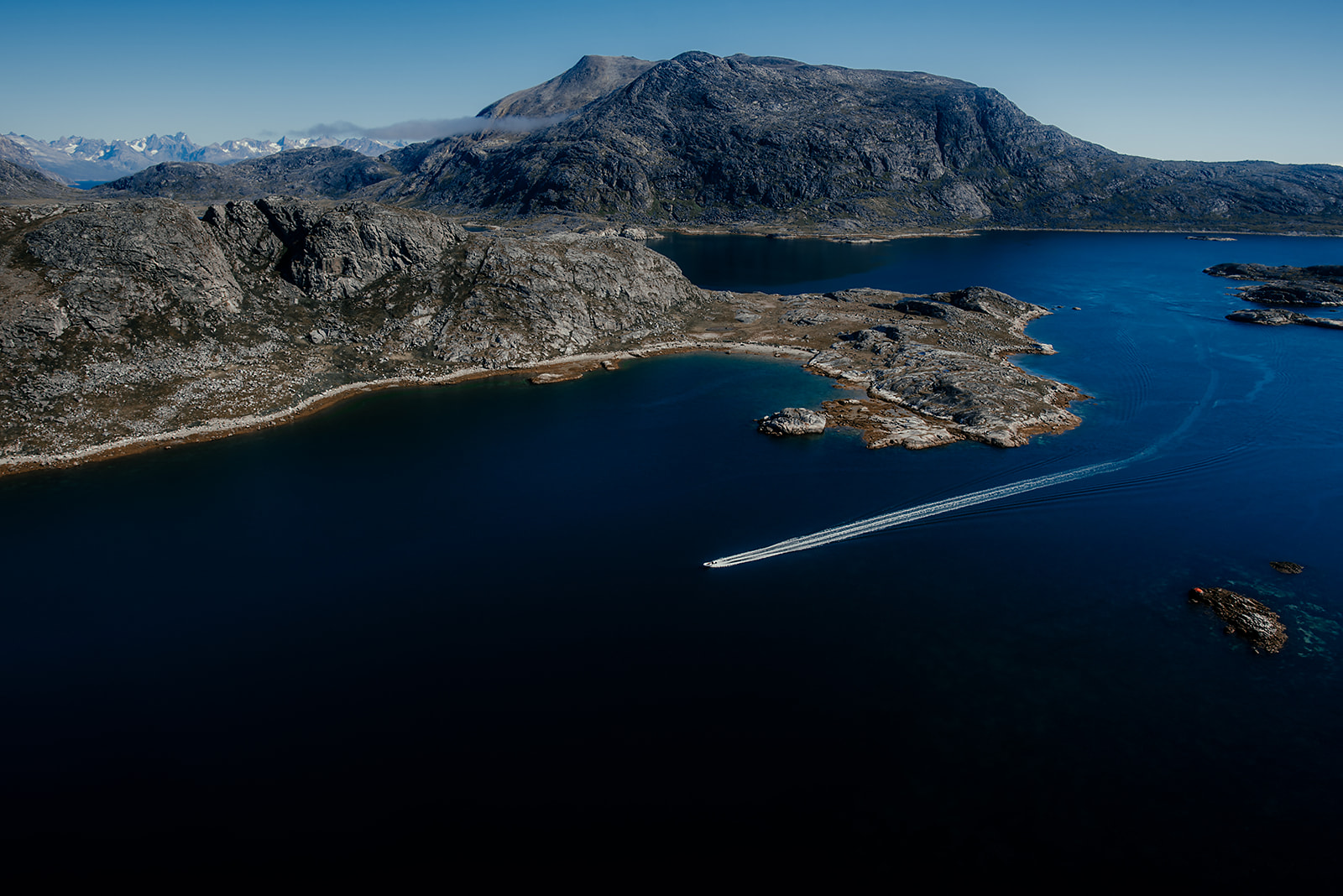 boat passing peninsula on Greenland