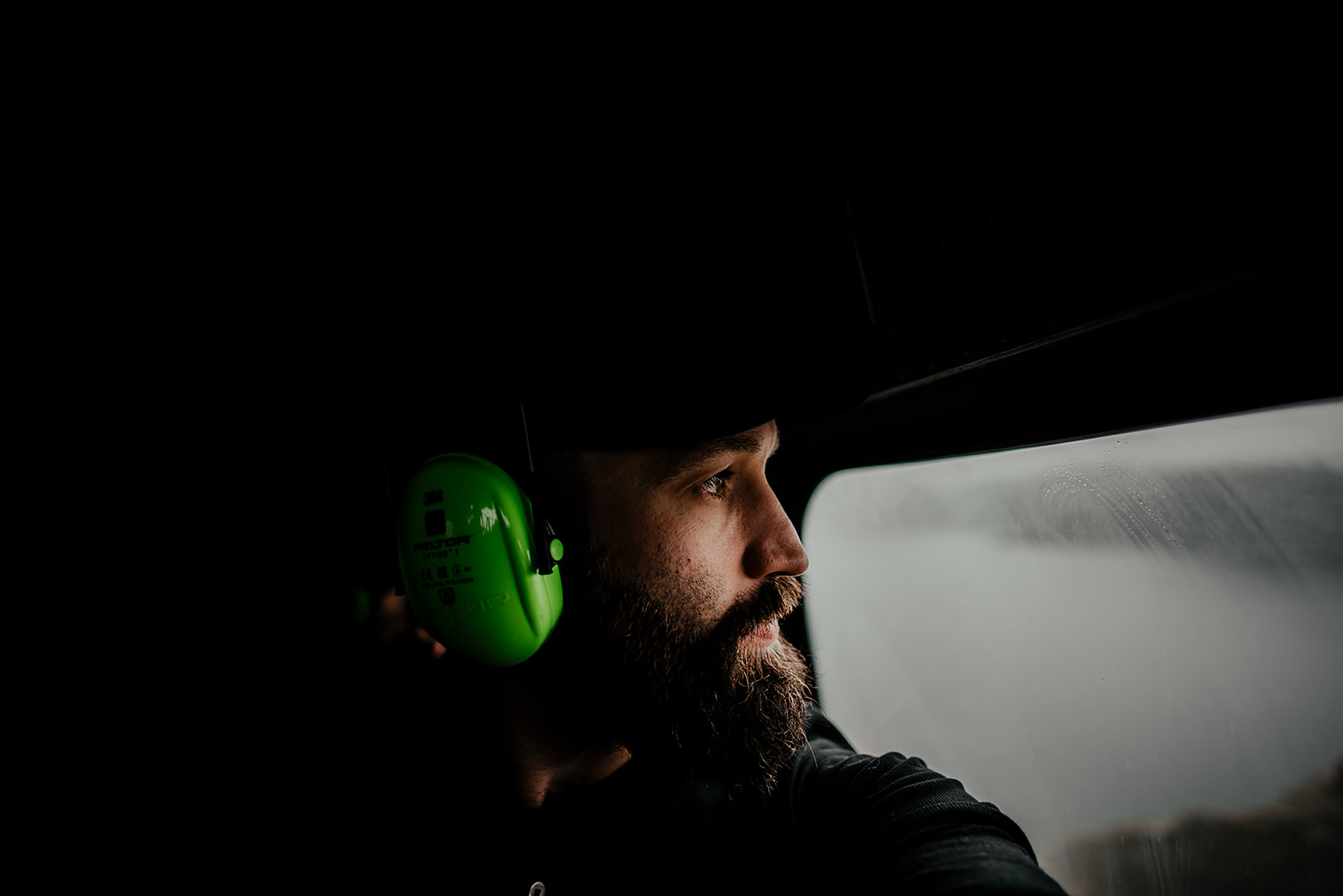 Chris Zielecki looking out of helicopter window on Greenland
