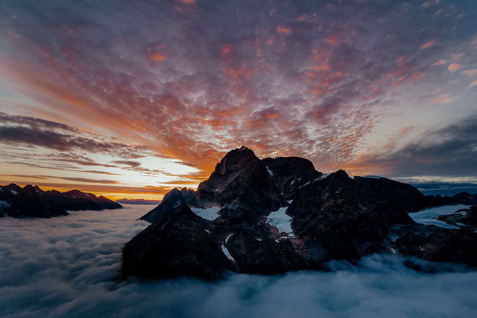 colourful clouds at sunset over mountain peak on Greenland