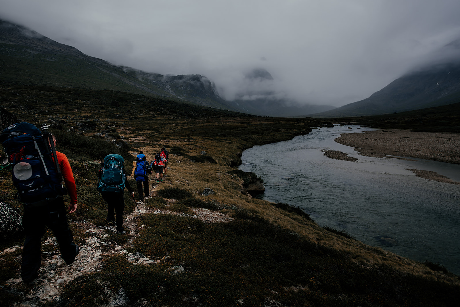 group of travelers following a river on Greenland