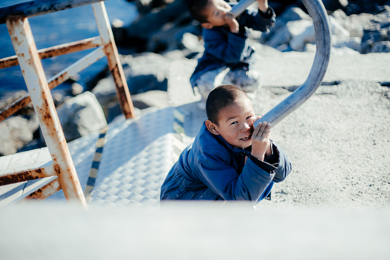kid playing with pipe on Greenland