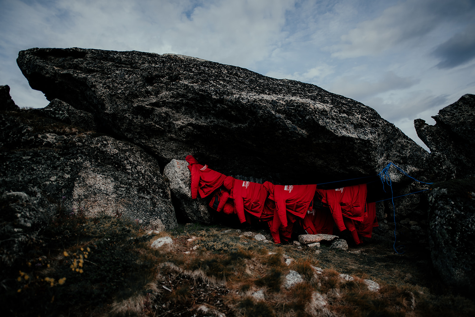 red adventure jackets on a rope on Greenland