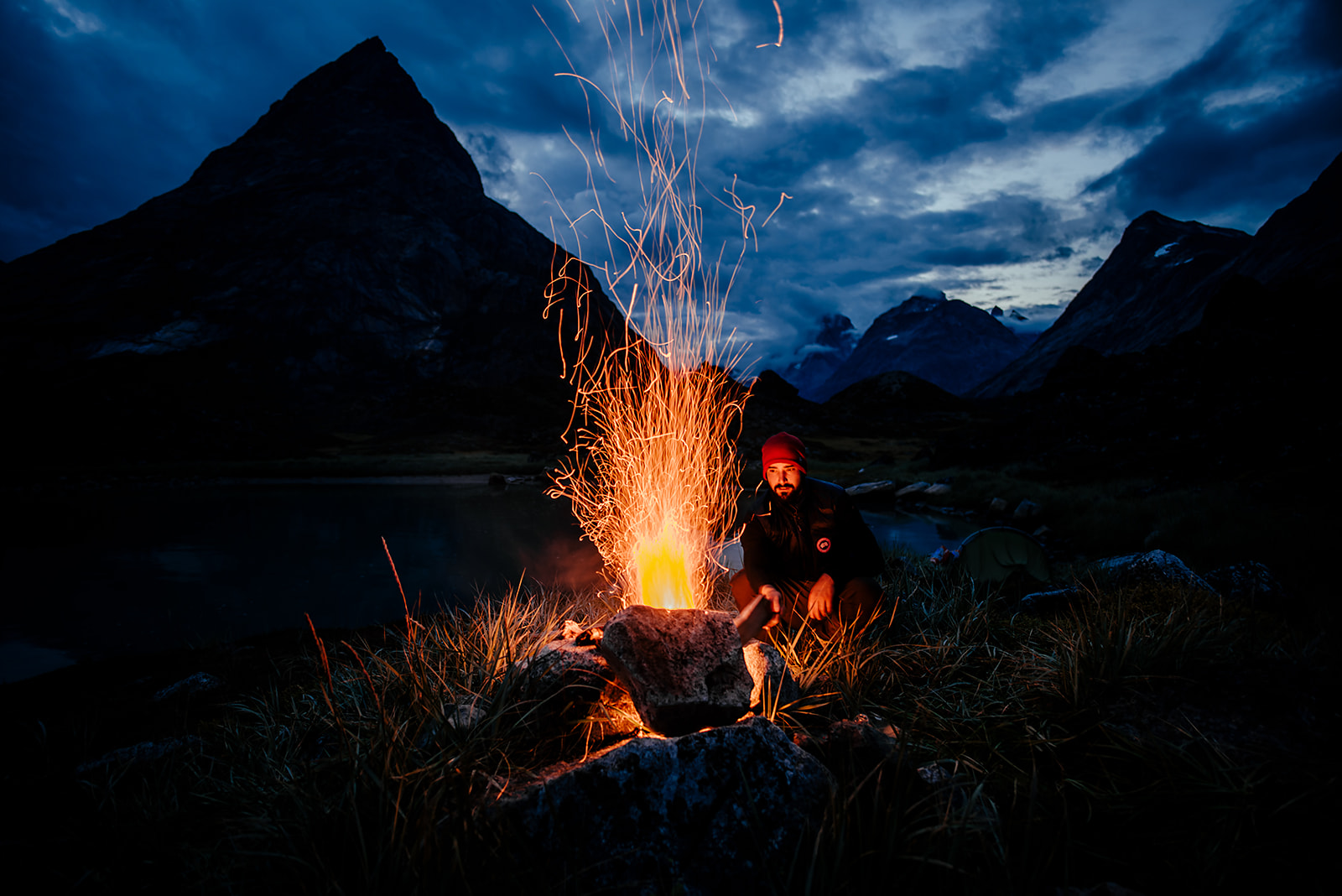 traveler setting up camp fire on Greenland