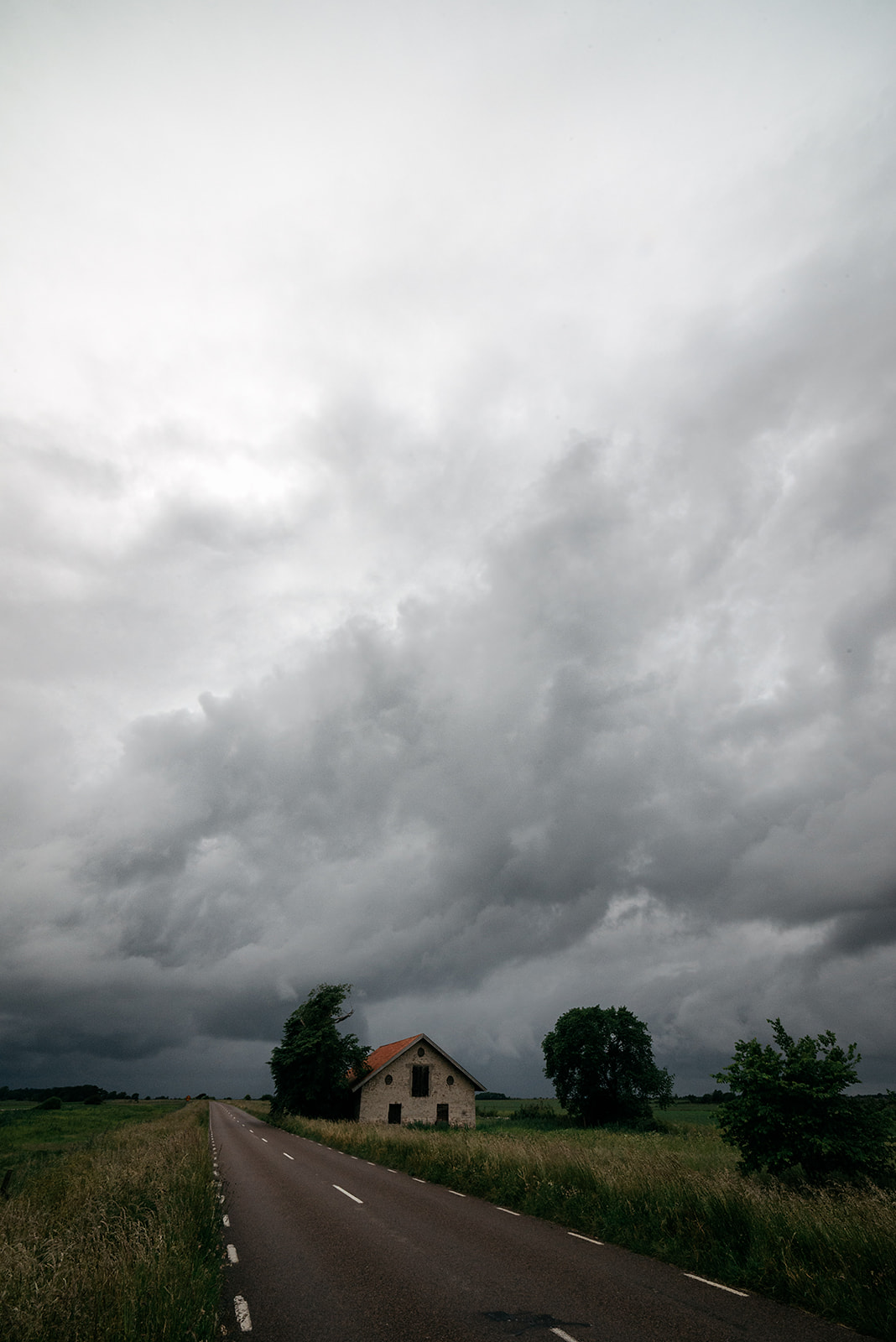 dramatic clouds over a farm house in Sweden