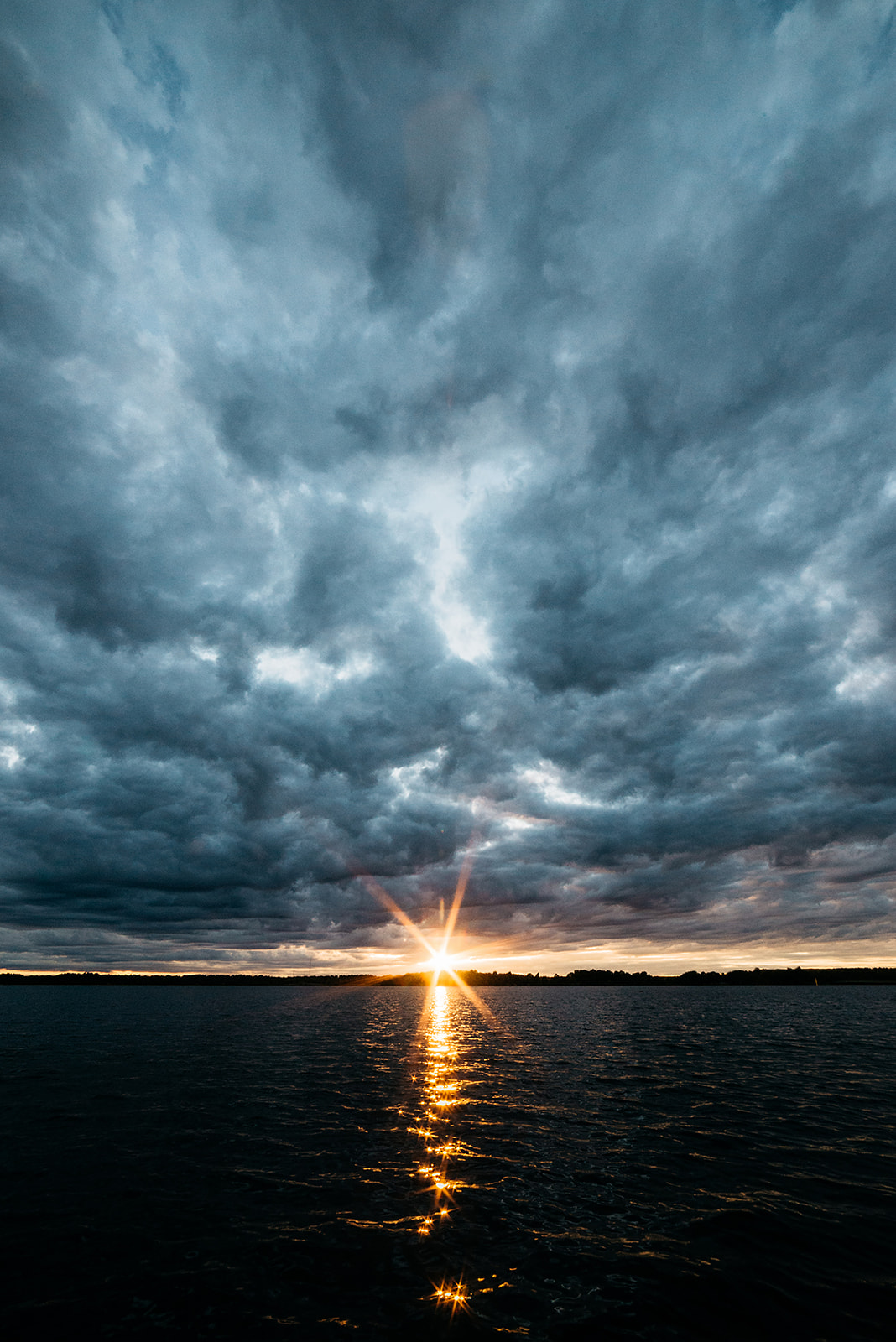 sunset over the baltic sea against a dark cloudy sky in Sweden