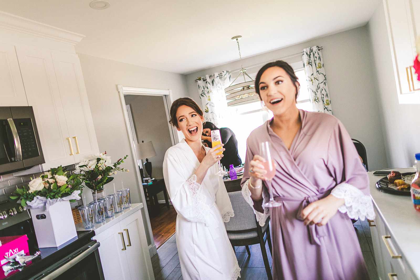 Bride getting ready in kitchen with friends
