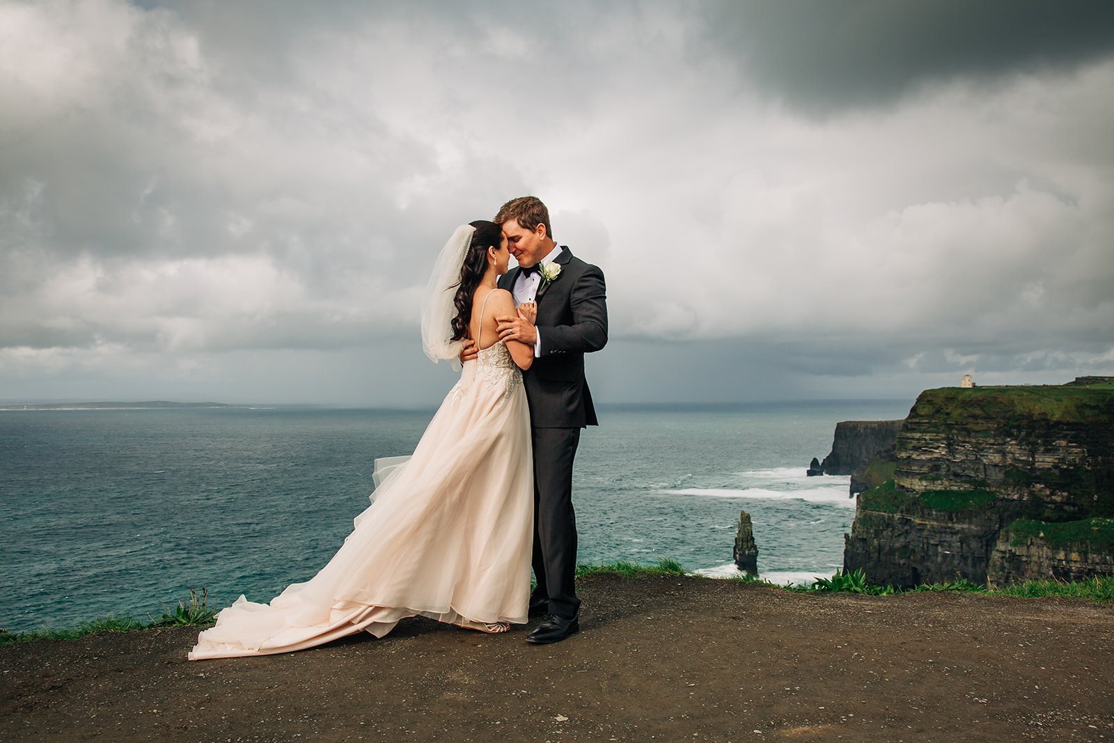 Bride and groom at the windy cliffs of moher