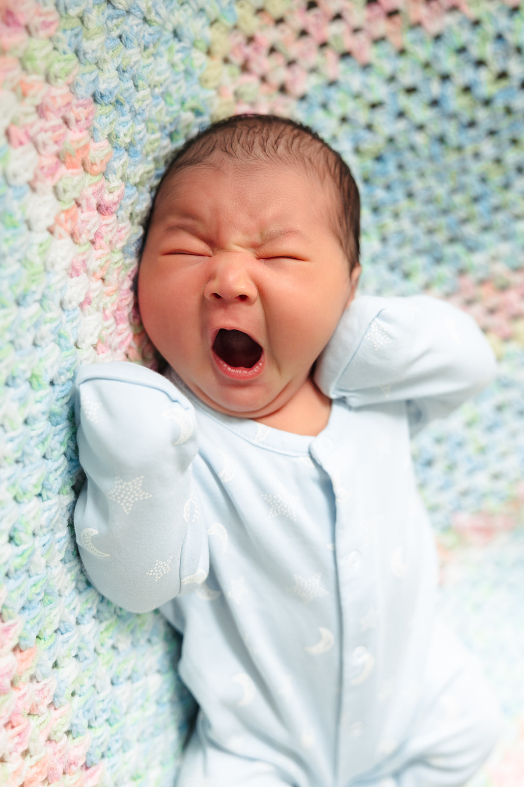 Baby boy yawning during his photoshoot