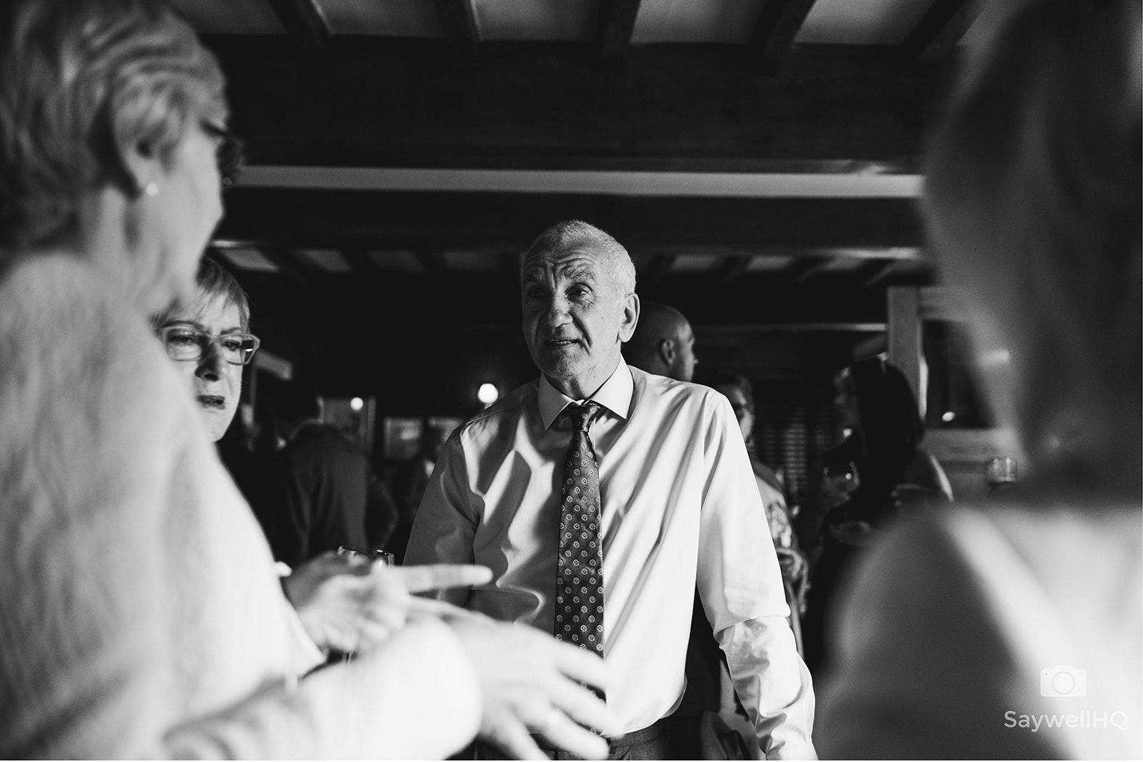 The Chequers Inn Wedding Photography - the wedding guest chatting in the bar at the pub