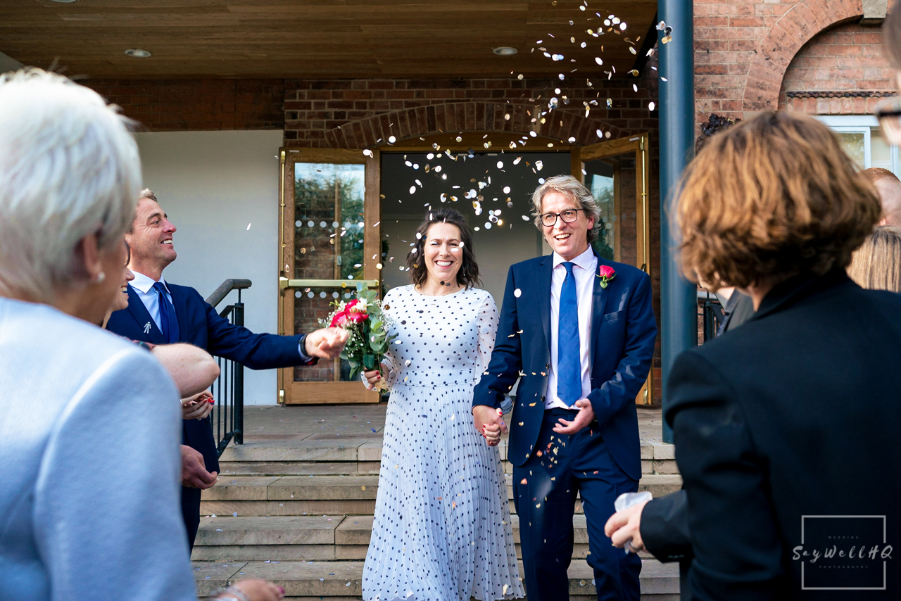 West Bridgford Hall Wedding Photography - bride and groom get covered in confetti following their wedding ceremony