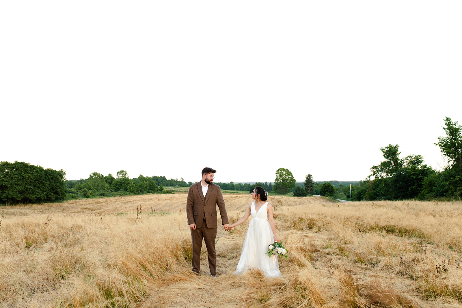 Majestic wedding photos in a wheat field during a beautiful Ohio sunset