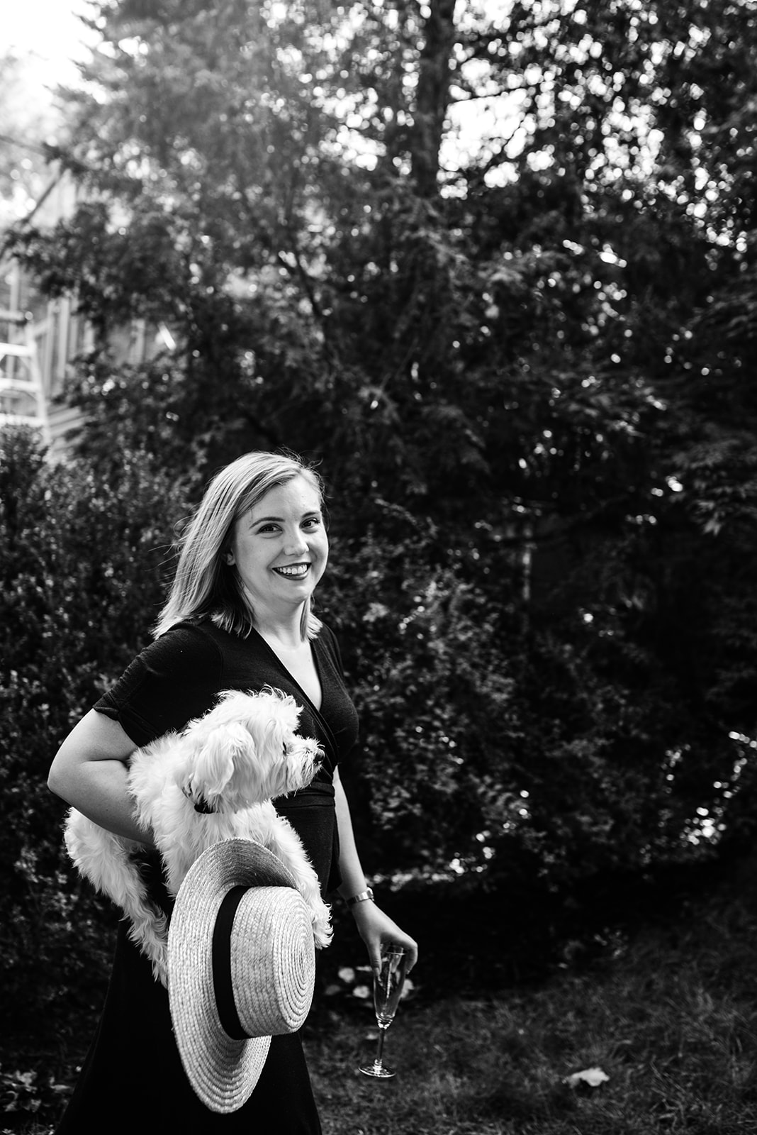 black and white portraited of newly engaged bride to be holding her pet dog
