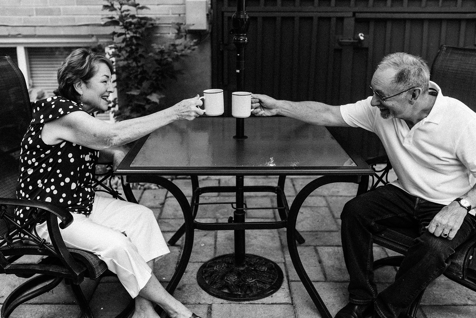 grandparents having coffee together sitting in the backyard in North York 