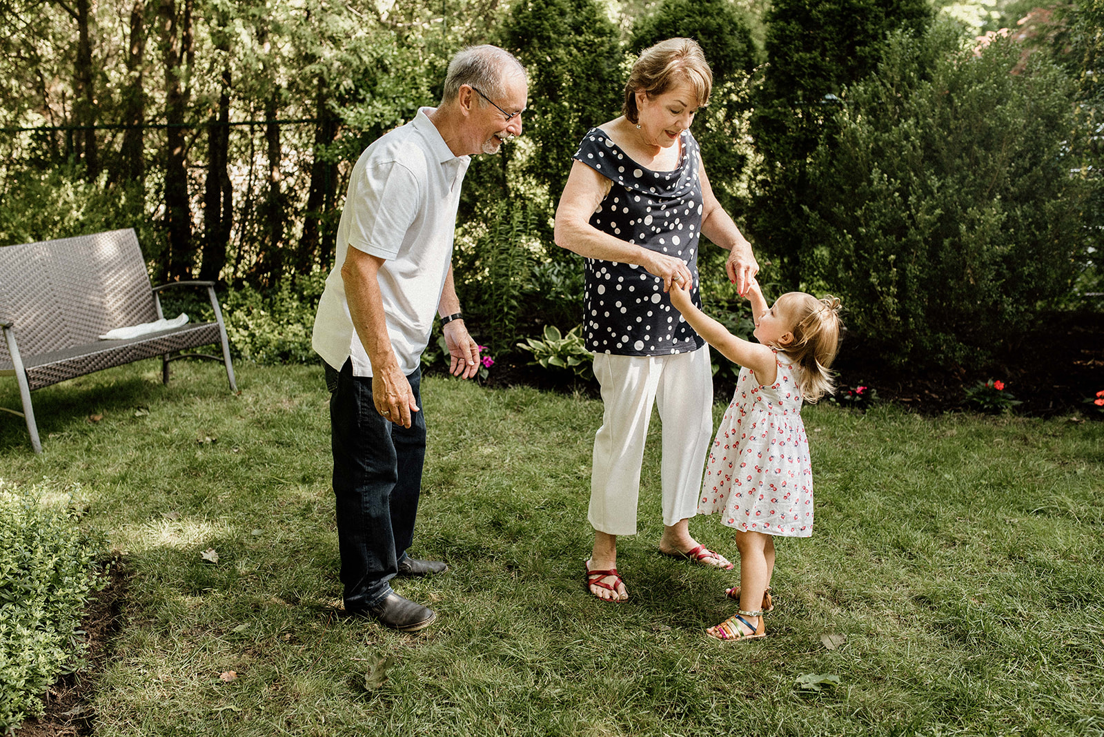Grandparents playing with their sweet little granddaughter
