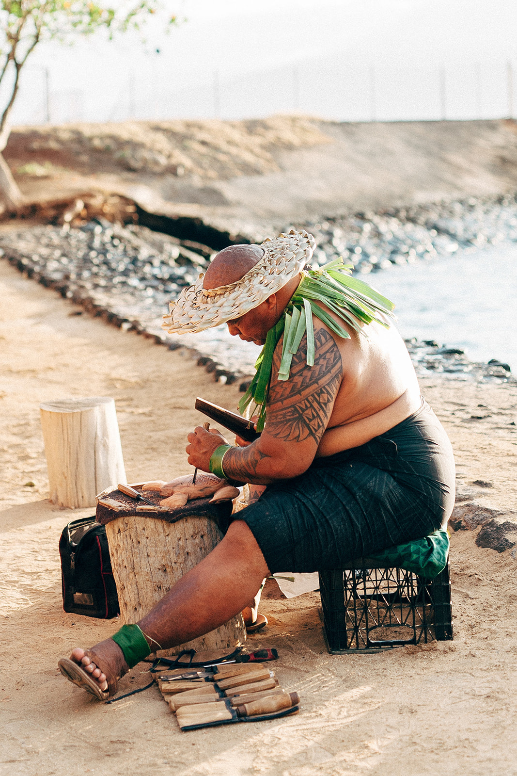 Hawaiian man cutting a coconut at Old Lahaina Luau