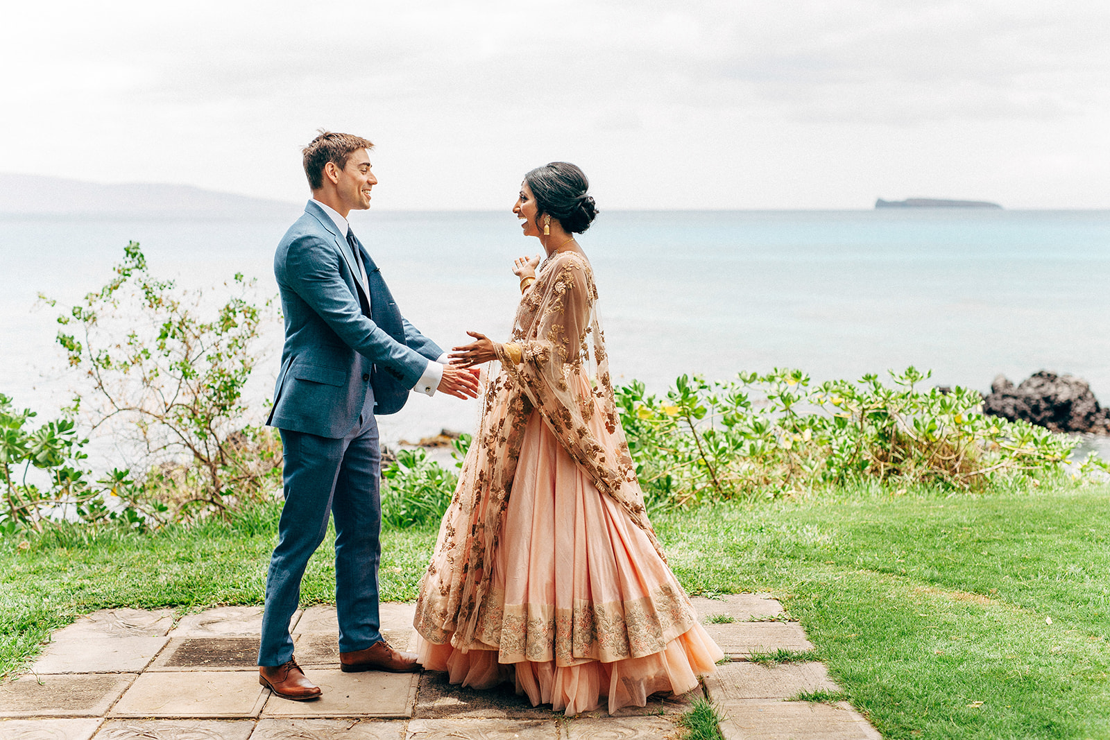 Bride and groom's first look by the ocean at Ponomakena Sanctuary in Maui