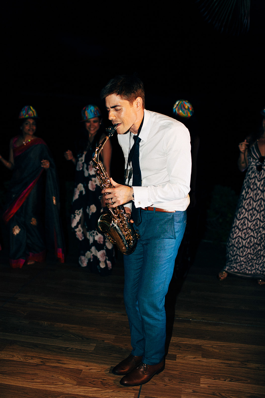Groom plays the sax for his new bride at their Maui wedding