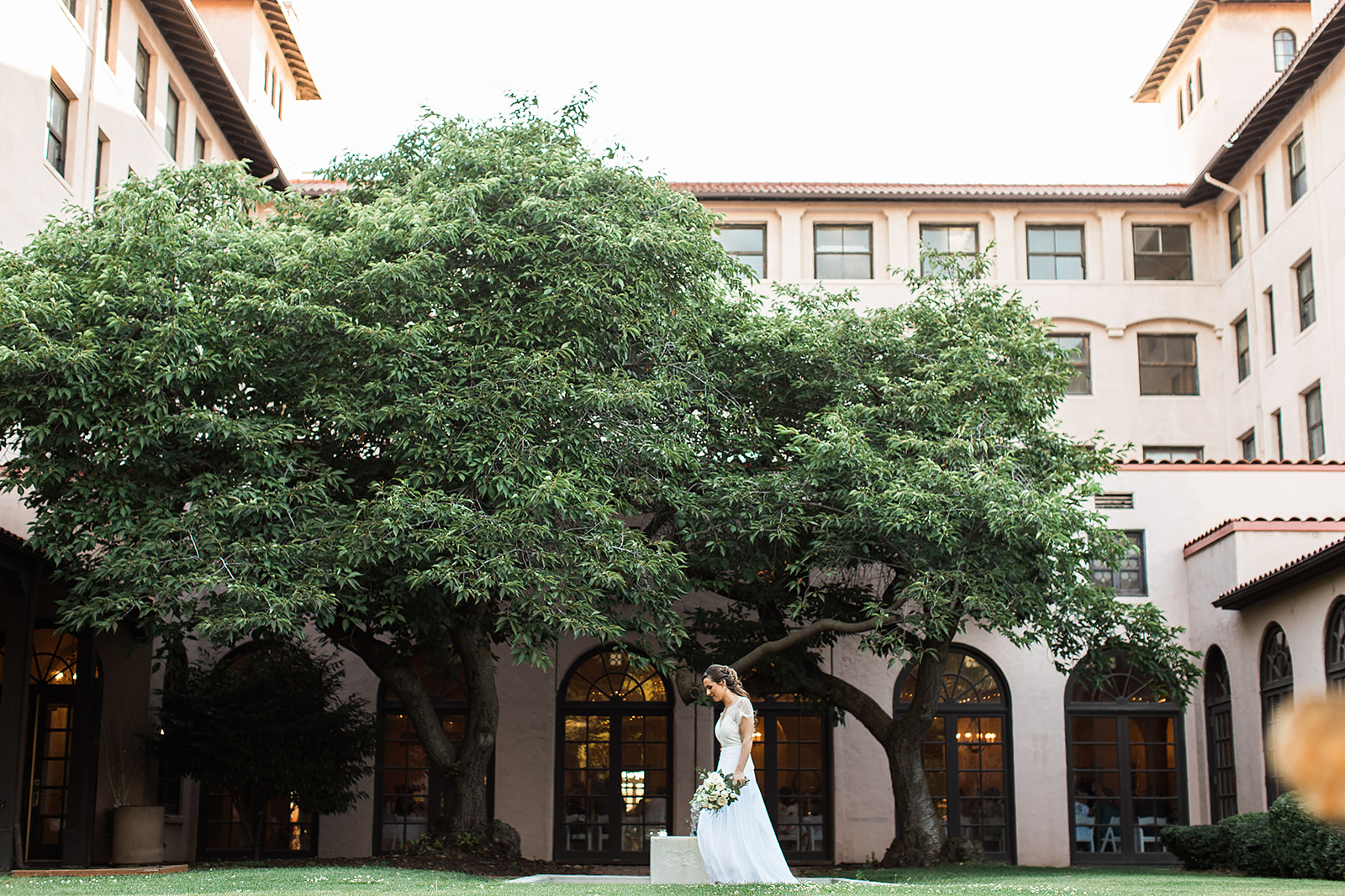 A bride strolls the grounds of the Lewis Clark Hotel on her wedding day before her ceremony 