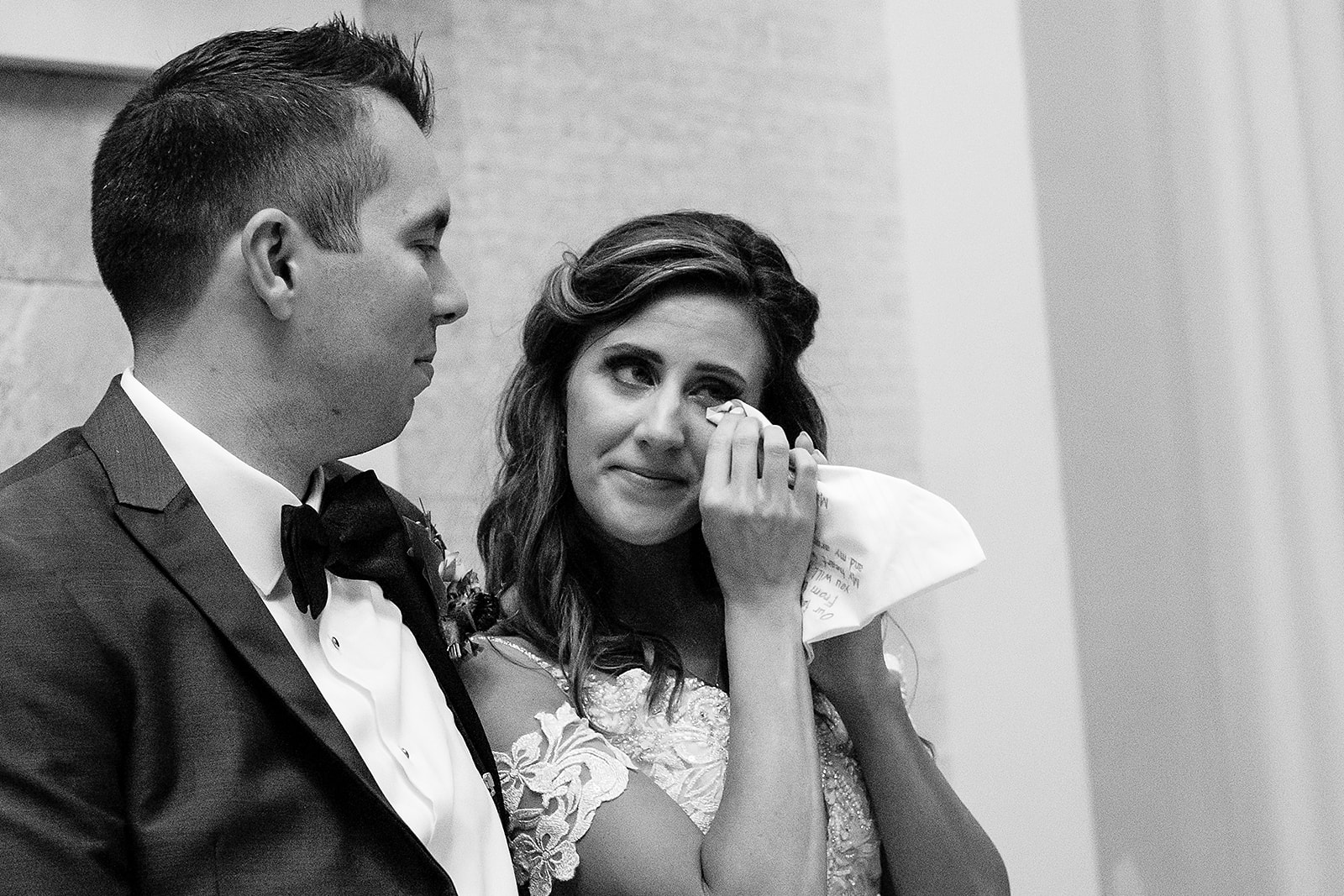 bride cries during wedding toasts at belle mer wedding reception 