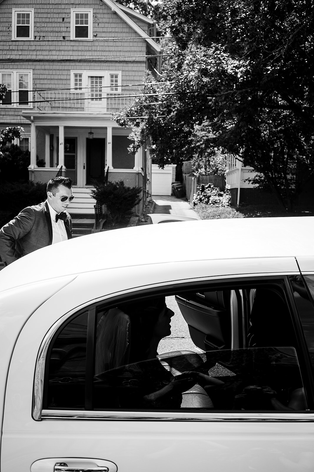 bride and groom get into limo after wedding ceremony at St. Sebastian’s Church in Providence Rhode Island