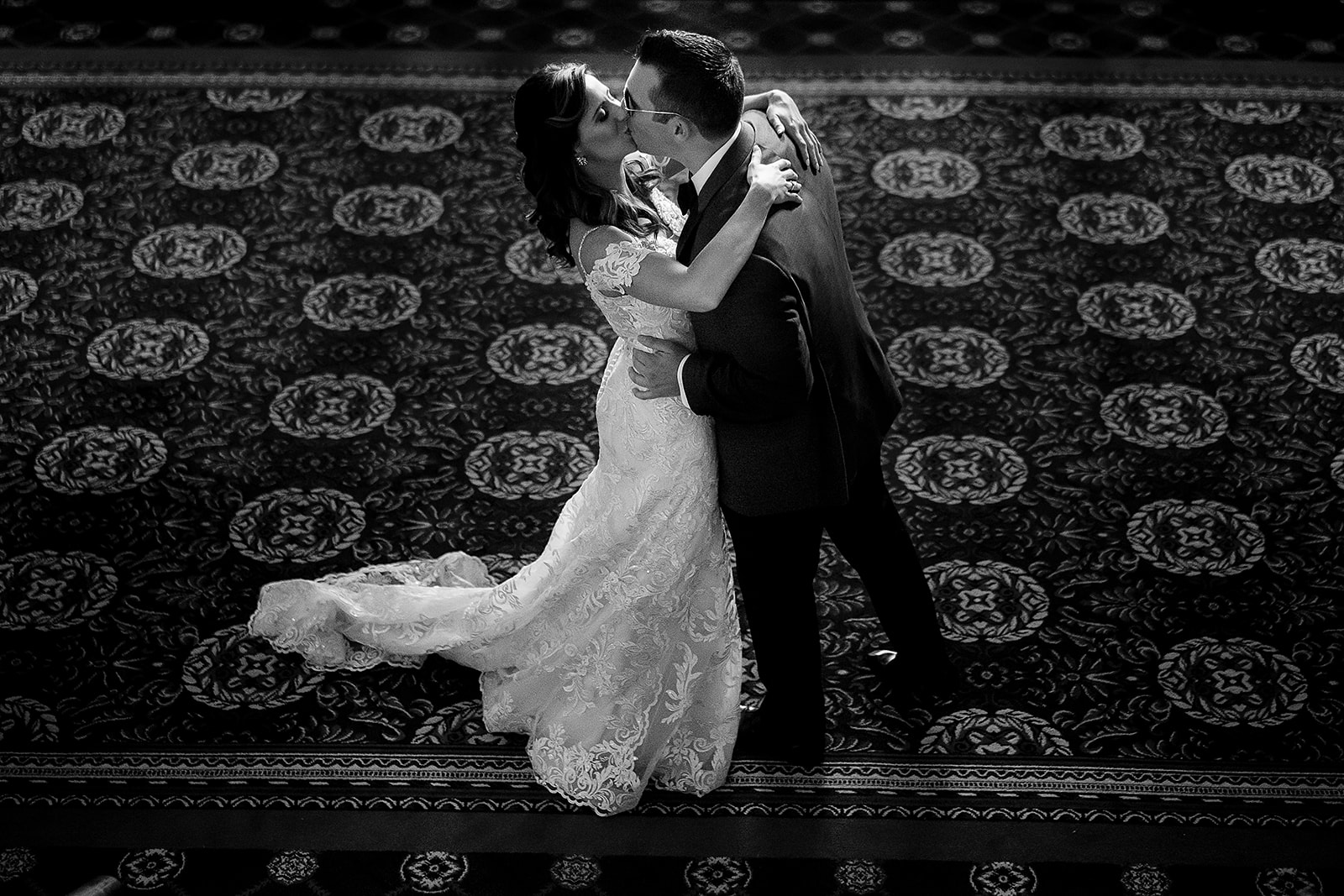 bride and groom kiss during first look at Graduate Providence hotel in Rhode Island 