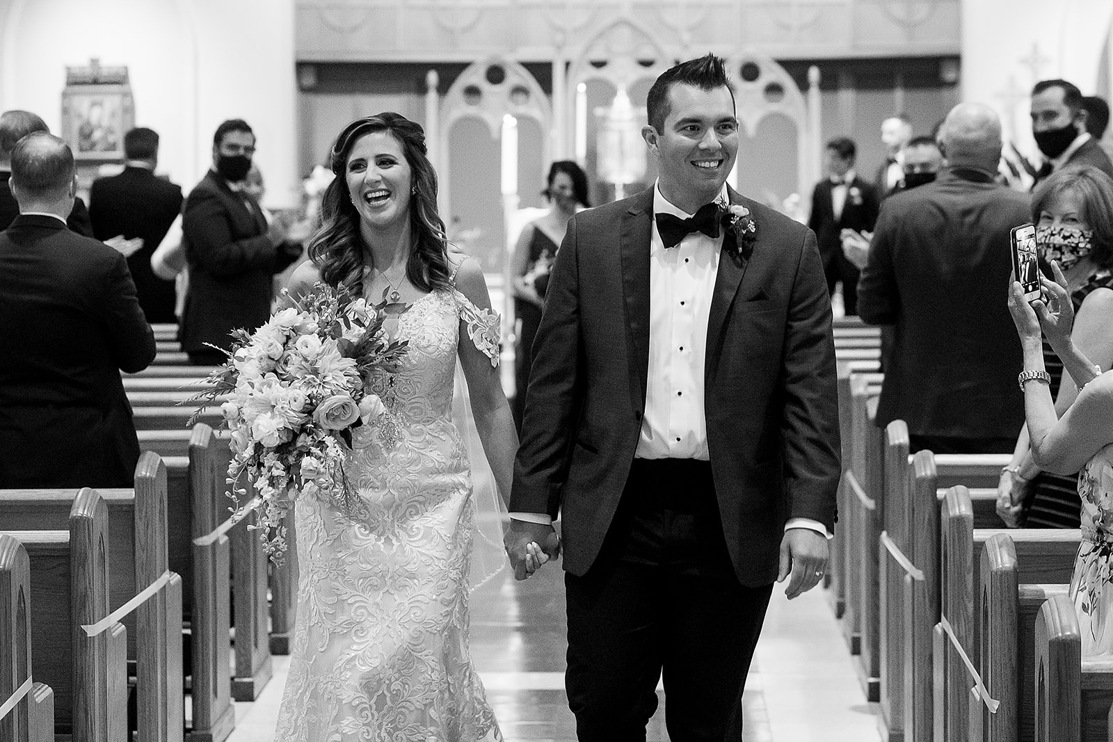 bride and groom walk down the aisle  after wedding ceremony St. Sebastian’s Church in Providence Rhode Island