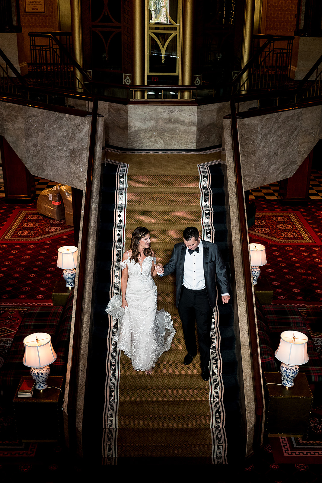 bride and groom walking down stairs of graduate hotel in Providence Rhode Island 