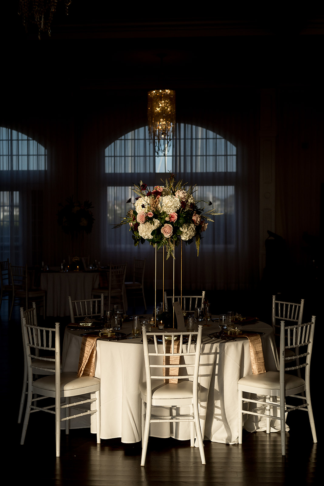 dramatic lighting on reception tables at belle mer wedding