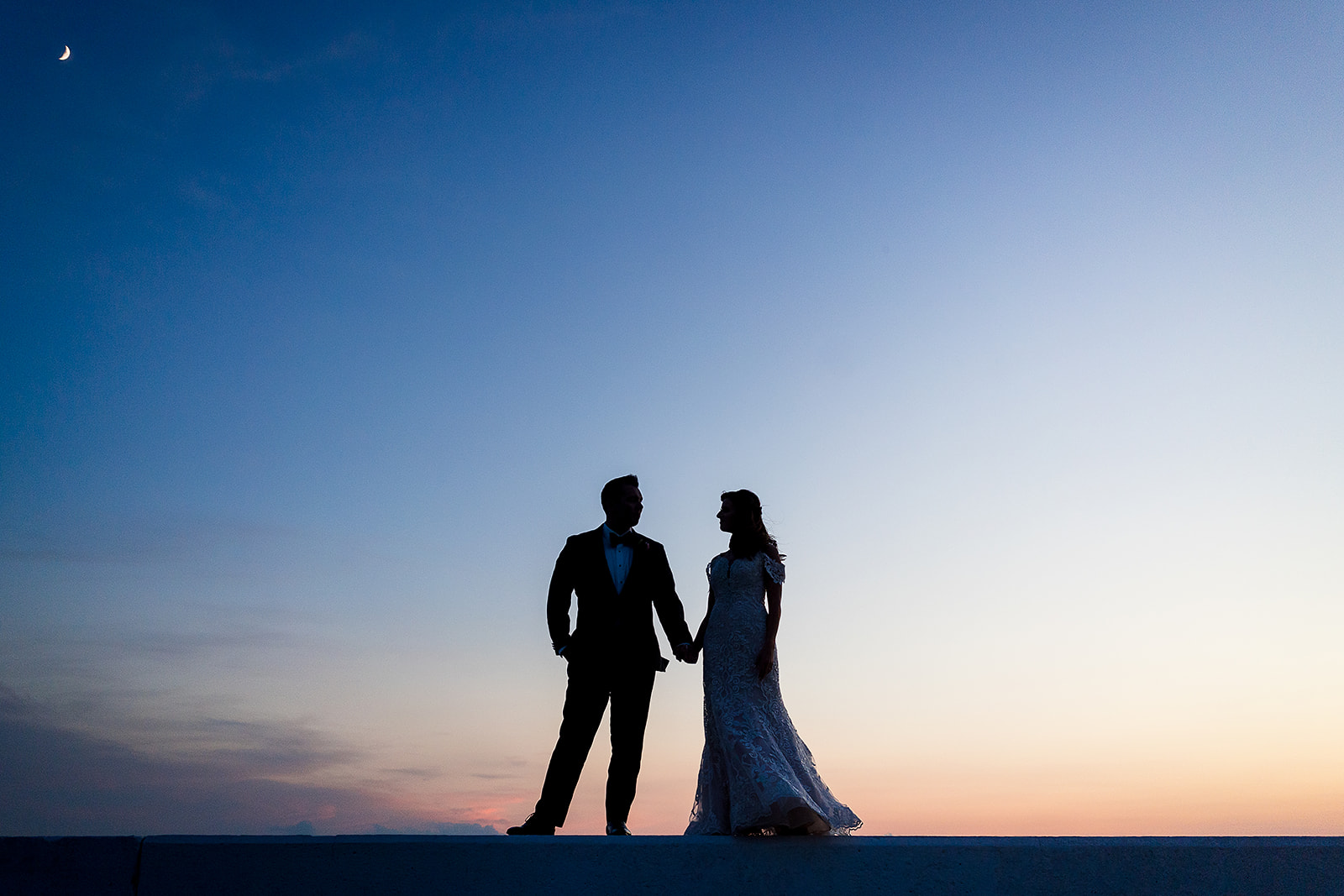 silhouette portrait of bride and groom at sunset at belle mer