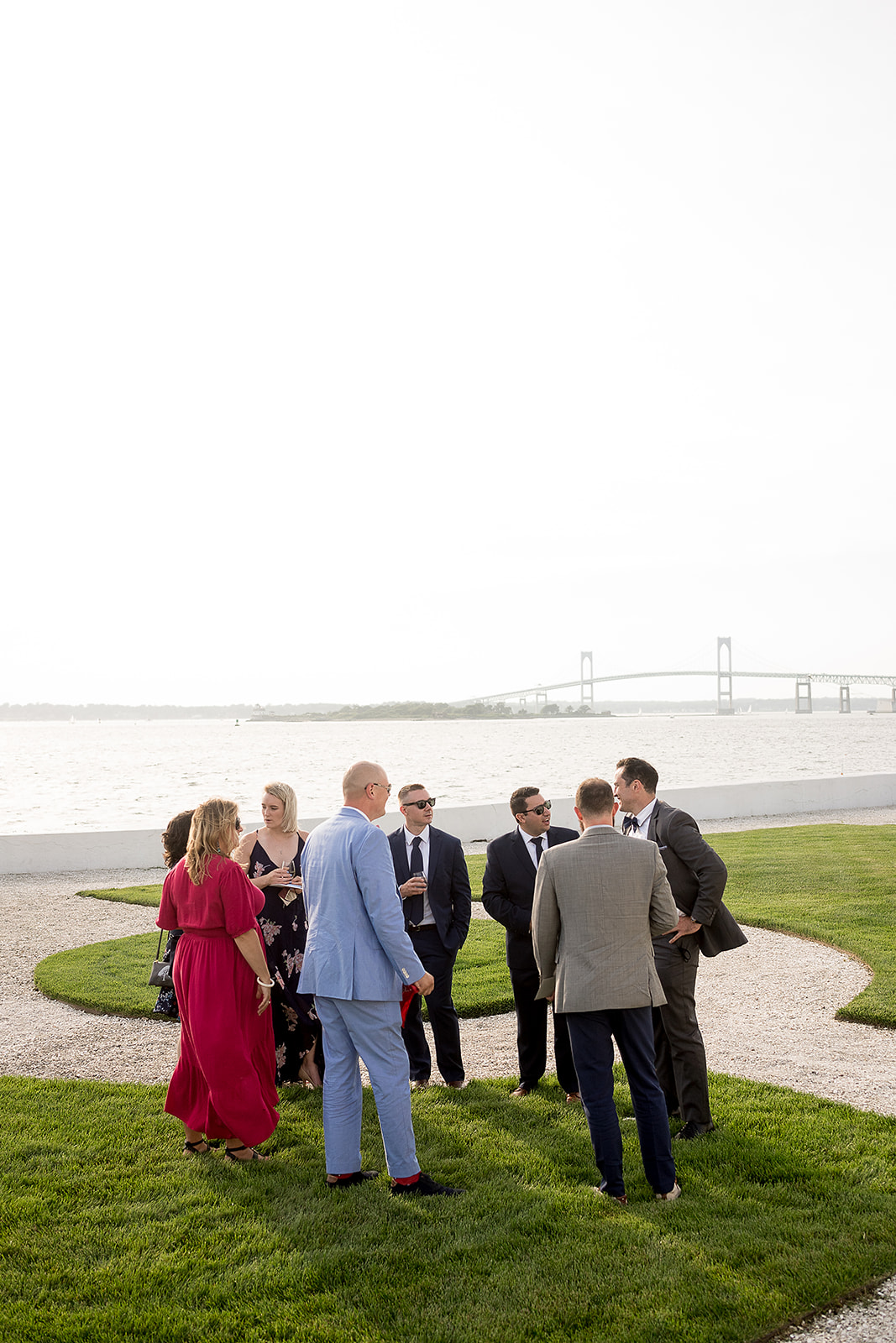 wedding guests enjoy cocktail hour by the water at belle mer