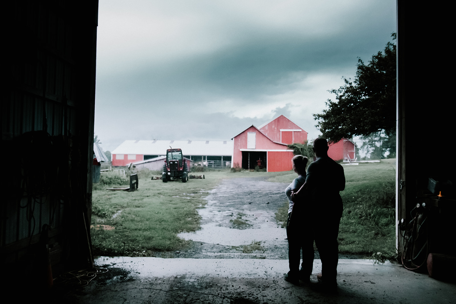 photos of a couple on a farm during a rain storm