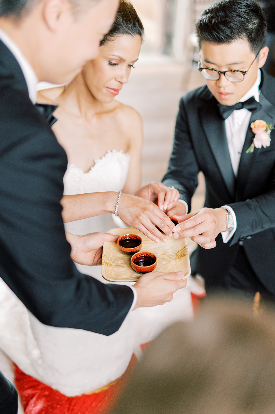 bride and groom share a cup for traditional tea ceremony at their spring Bartram's Garden wedding in Philadelphia, PA
