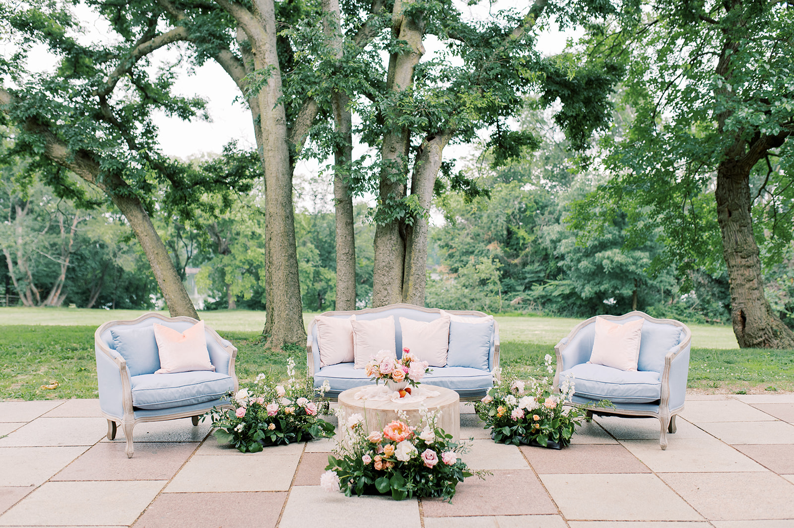 chic blue and peach lounge set up for a parisian inspired spring wedding at Bartram's Garden