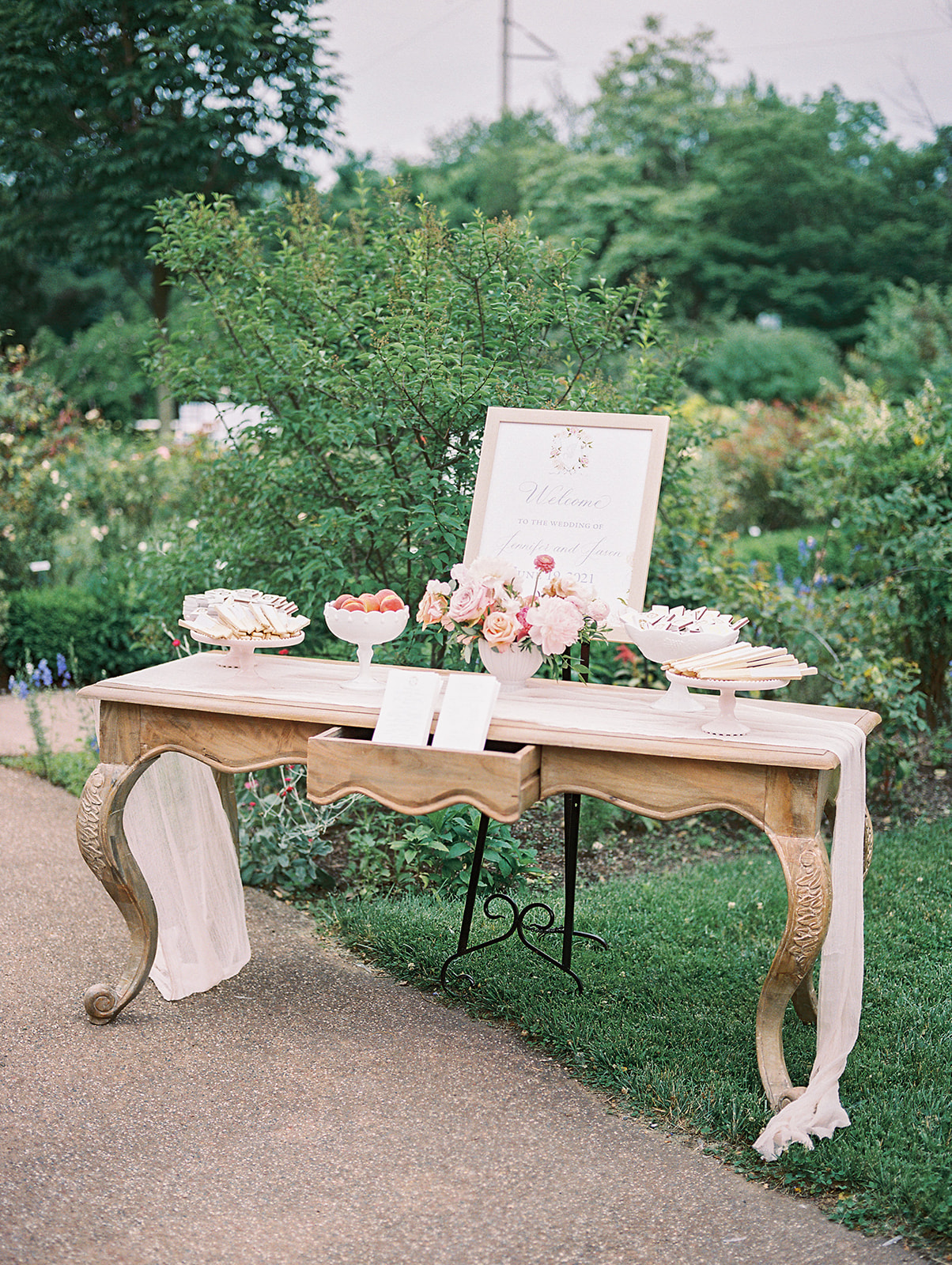 parisian inspired welcome table at peachy spring Bartram's Garden wedding