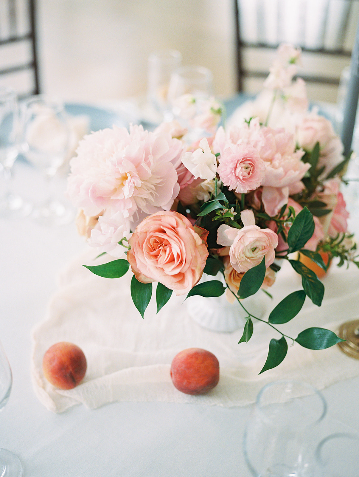 soft peachy romantic florals for a centerpiece at parisian inspired spring Bartram's Garden wedding