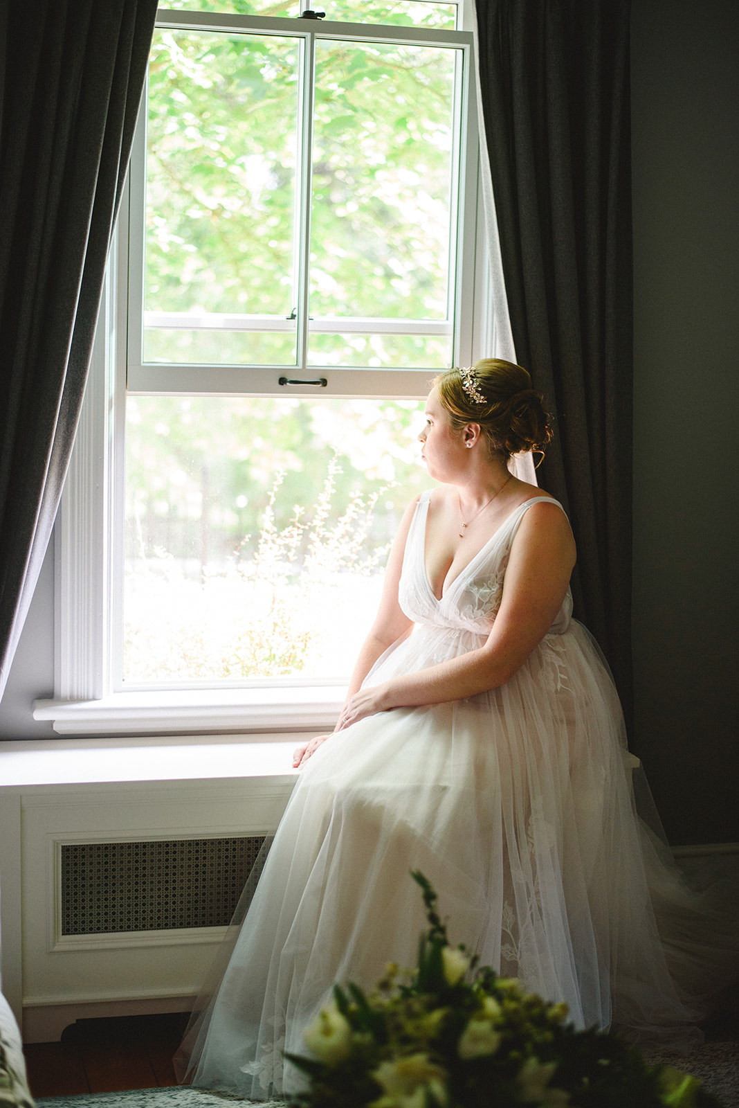 A bride just about to get married at her home in Newmarket staring out the window. 