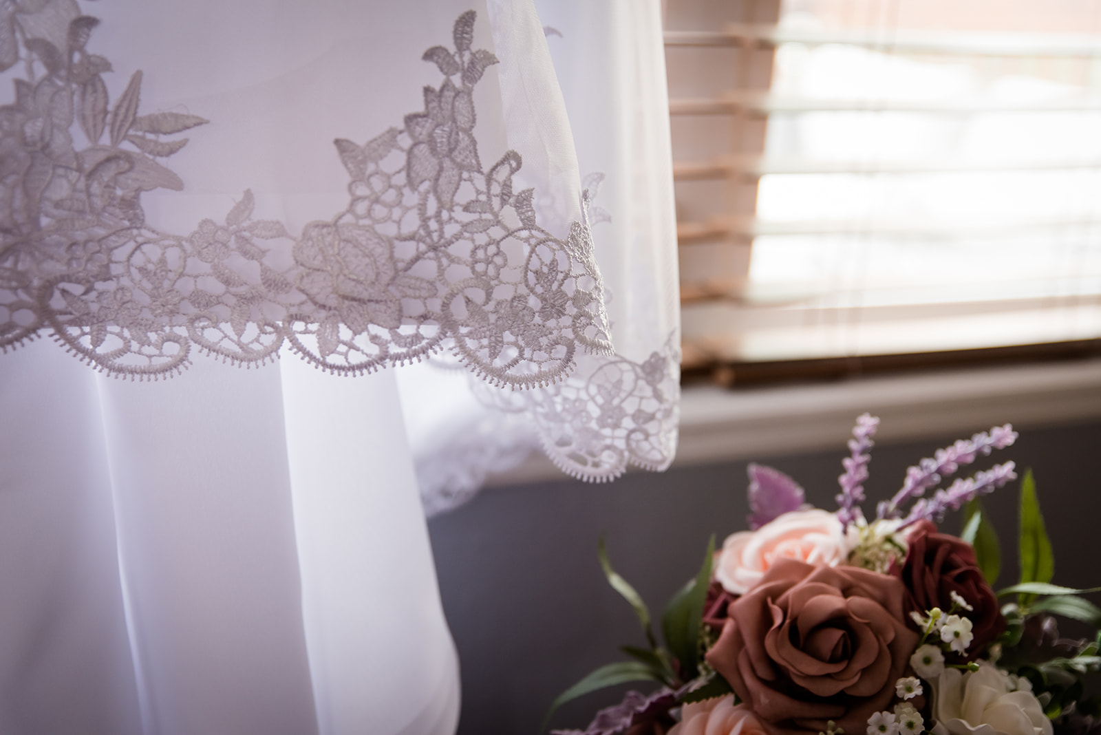 detail of the bride's dress with her flowers