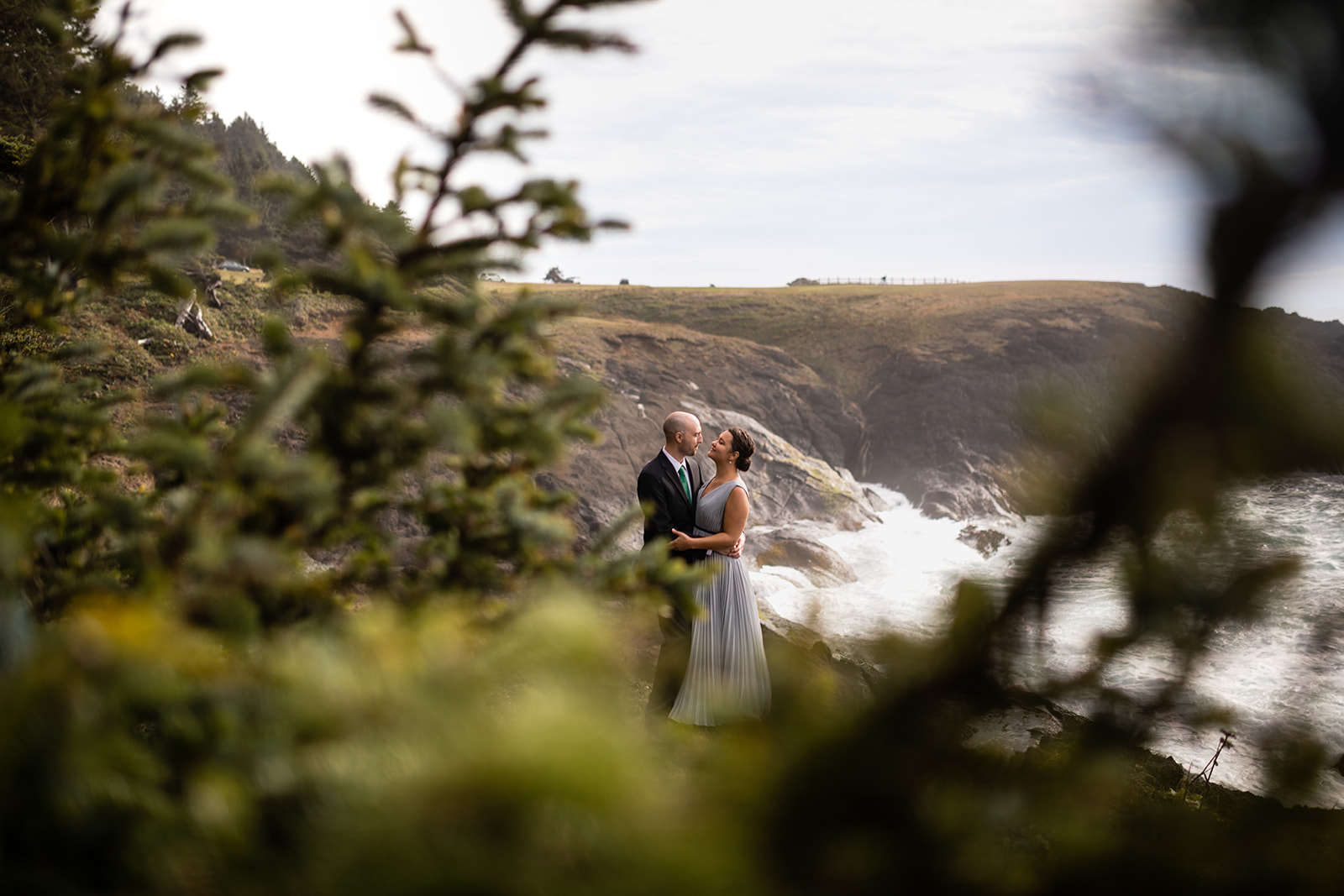 Couple in wedding attire at Boiler Bay in Oregon 