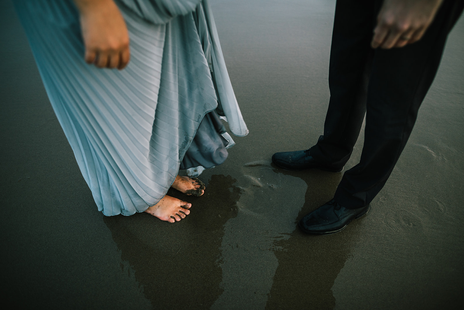wedding couple feet in sand