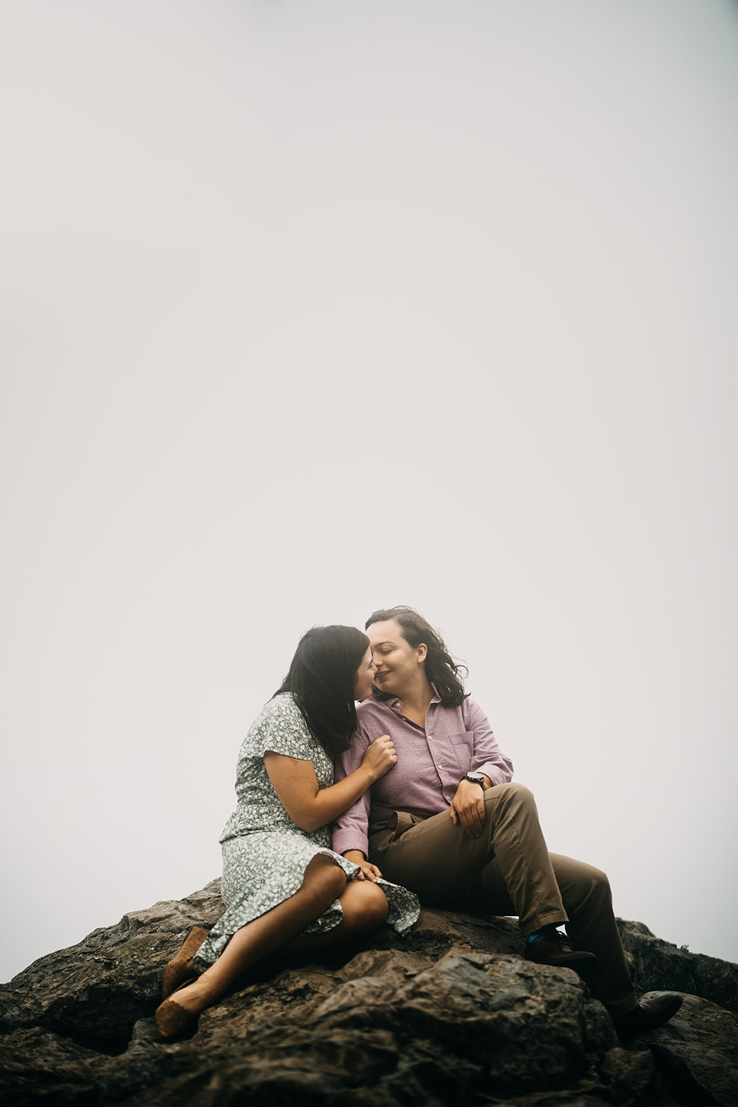 Queer couple on a mountaintop surrounded by fog in Shenandoah National Park