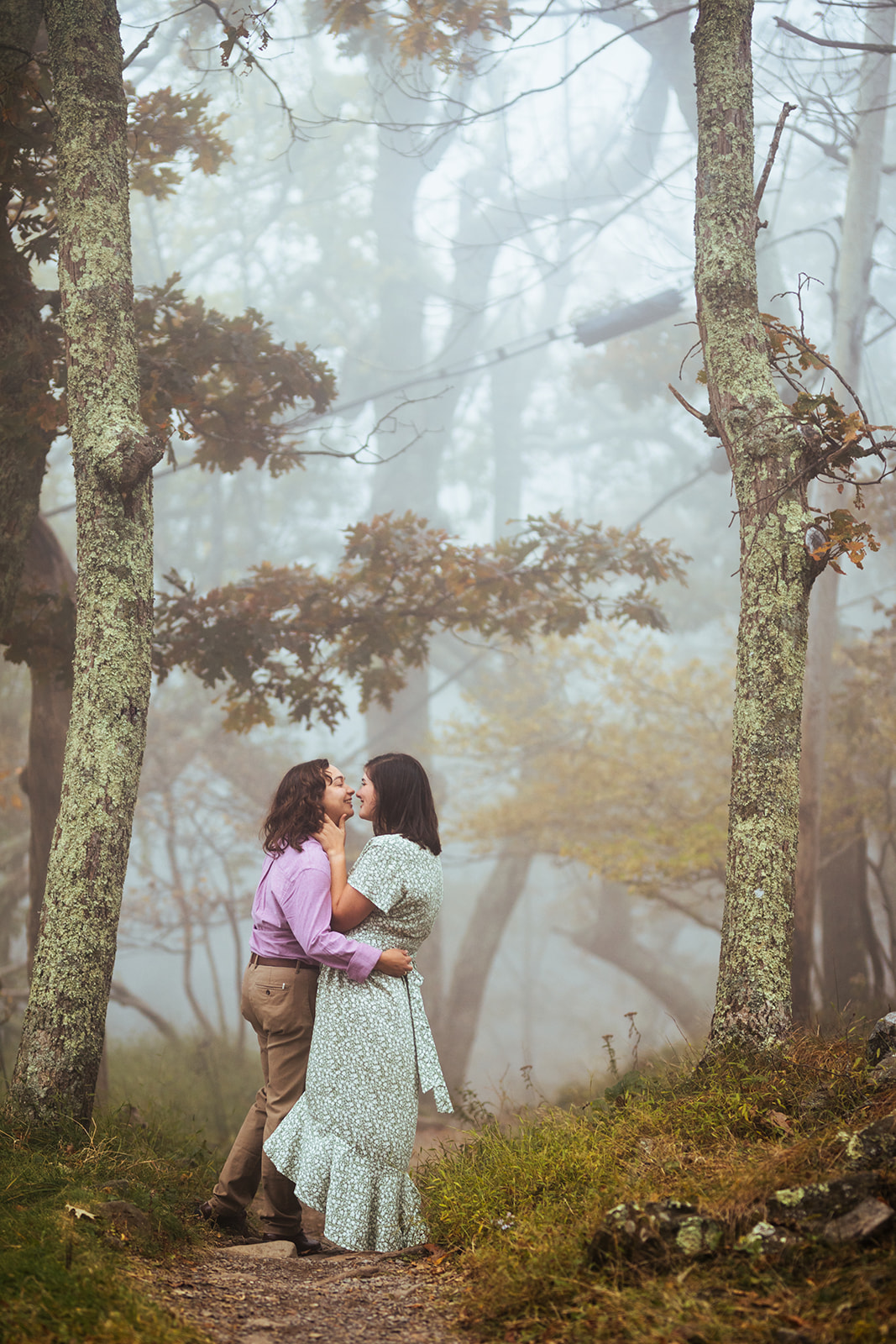 Spooky dramatic lesbian woodland engagement photo