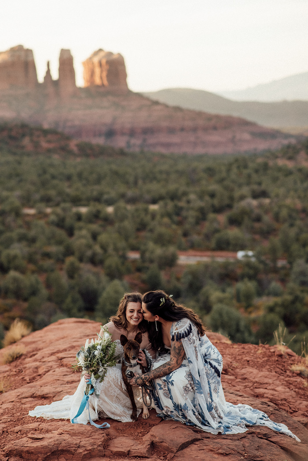 lgbtqia+ elopement couple with dog and views of Cathedral rock in Sedona, AZ
