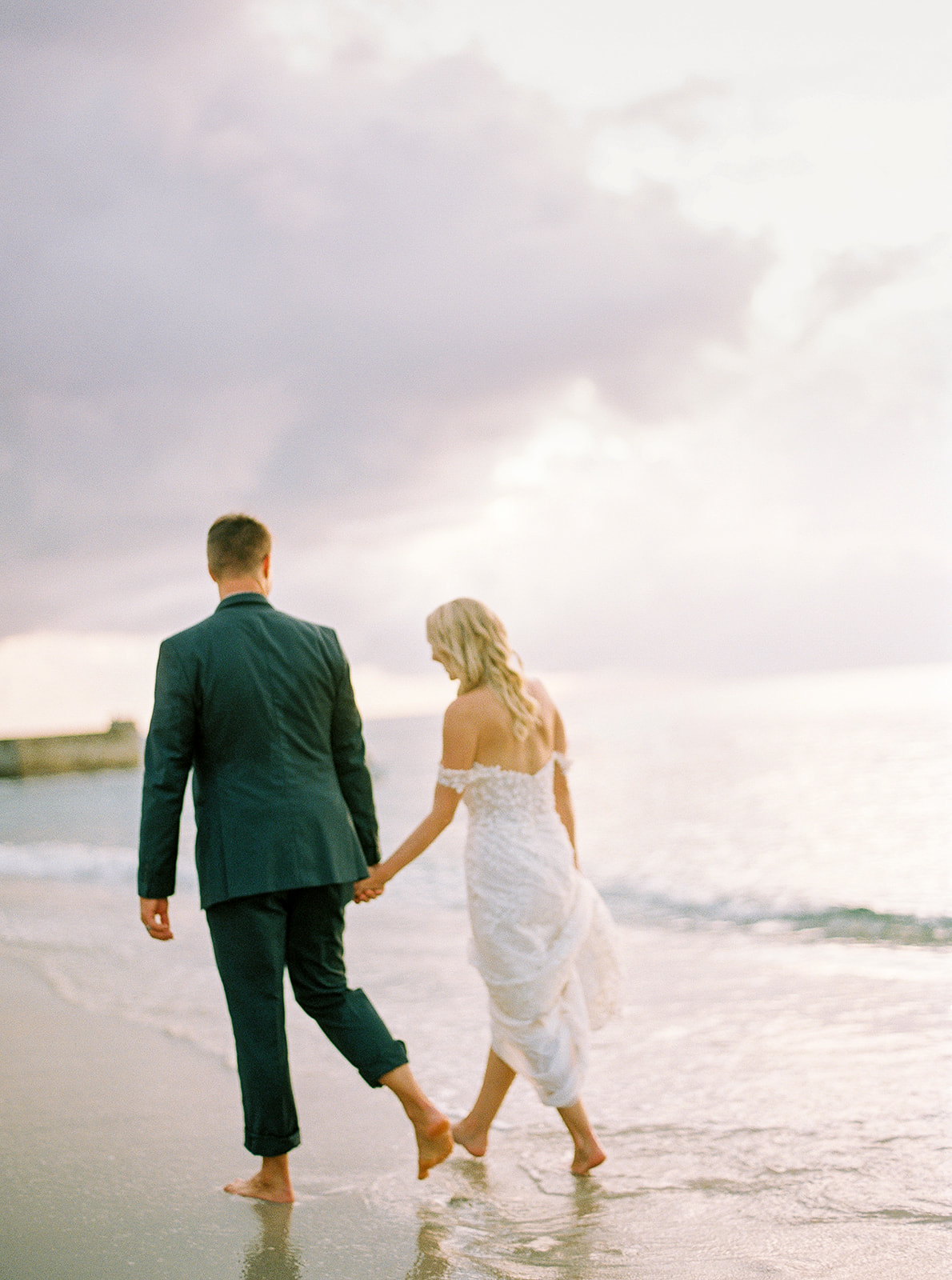 Bride and groom walking into the sunset at Sugar Beach St. Lucia