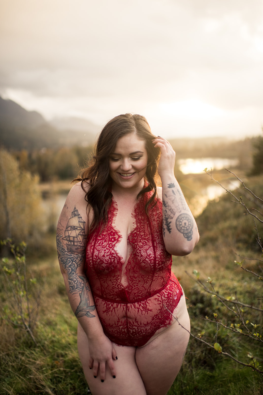 pacific northwest woman wears red lingerie at Government Cove Peninsula for her boudoir session