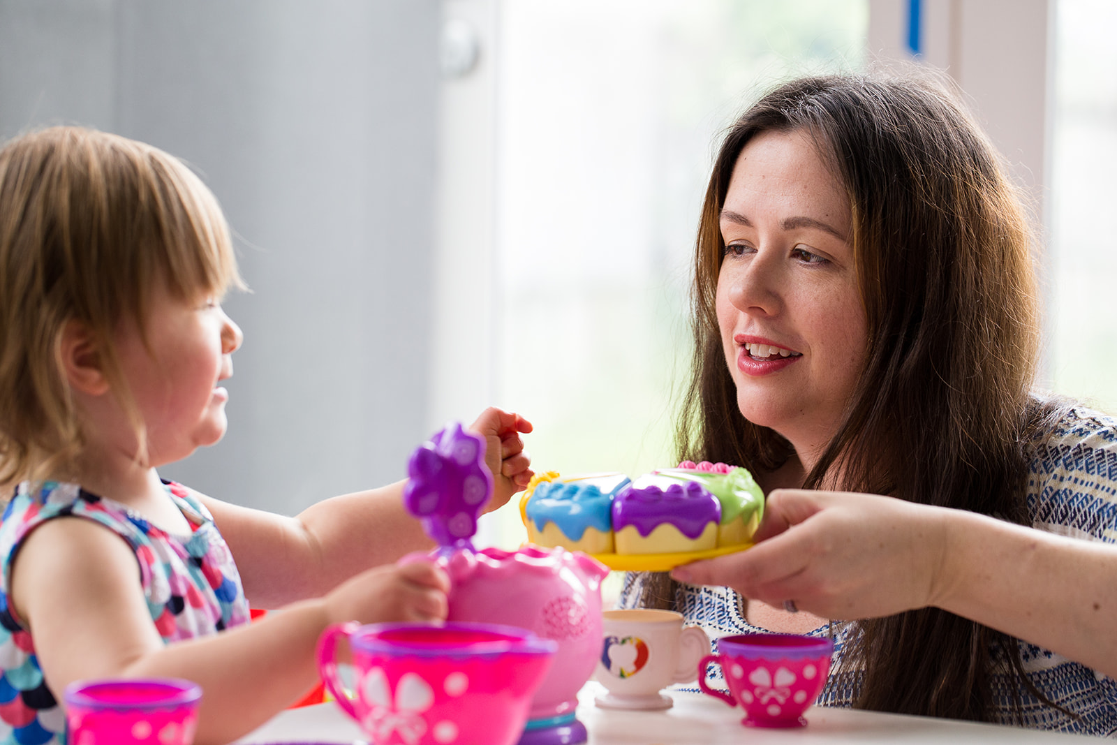 mother and toddler having a tea party at home