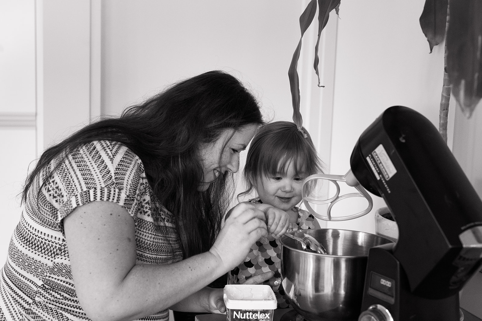 mother and toddler making a cake at home