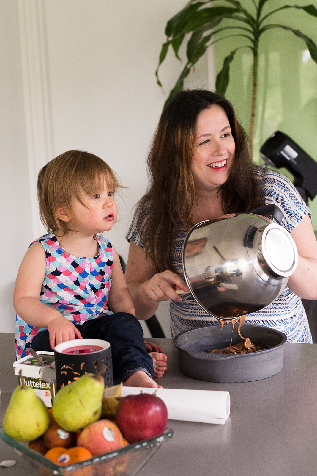 mother and toddler making a cake at home