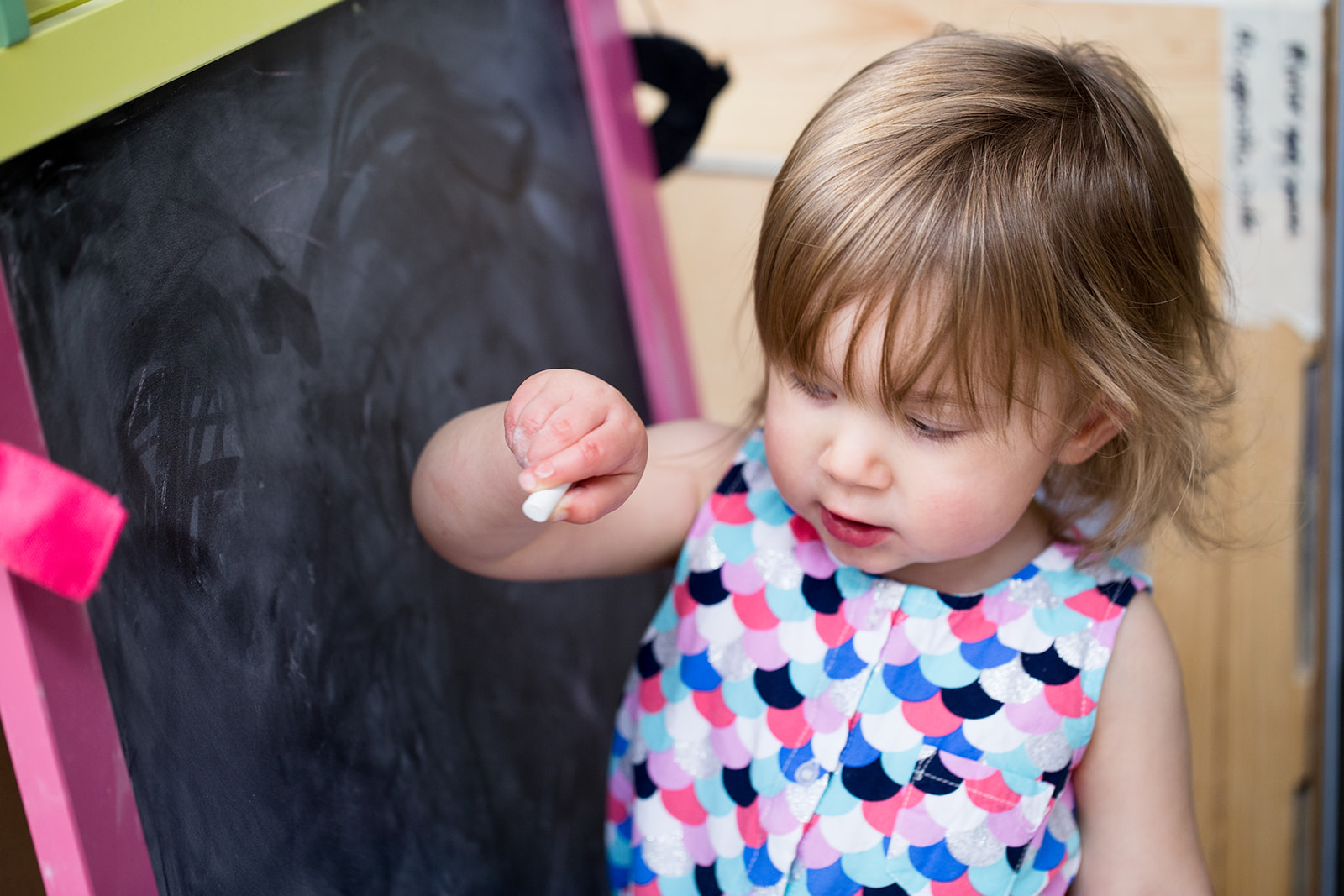 toddler drawing on chalk board