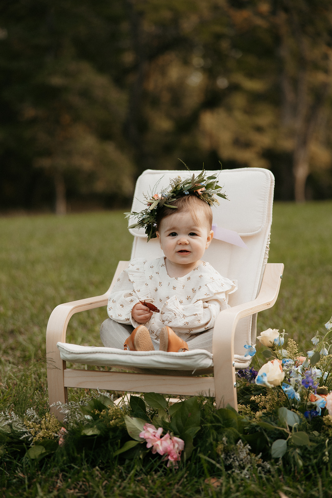 A one year old celebrates with her flower crown.