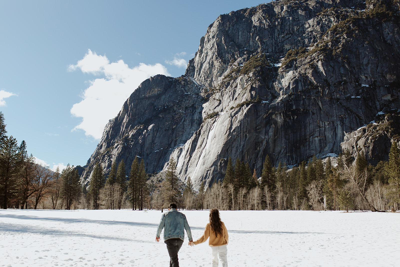 couple enjoys snow-capped mountains at Yosemite engagement session